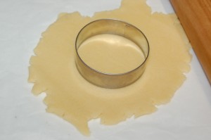 Rolled Dough Being Cut Out With Rounds